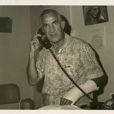 An unknown man using a telephone