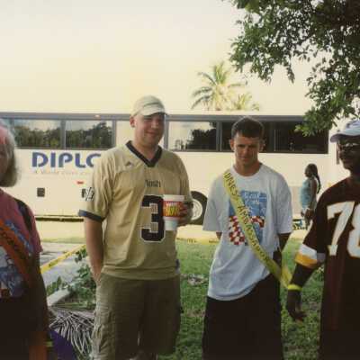 Unknown people standing around.