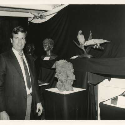 Unknown man standing next to sculptures