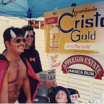 Unknown man dressed up standing next to the Cristal gold booth.