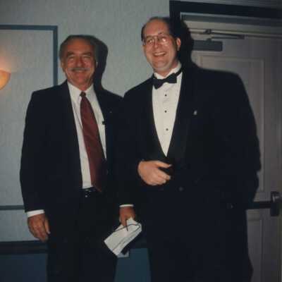 Two unknown men in suits.