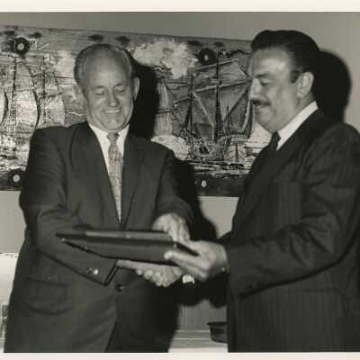 Unknown men looking at a plaque at a dinner