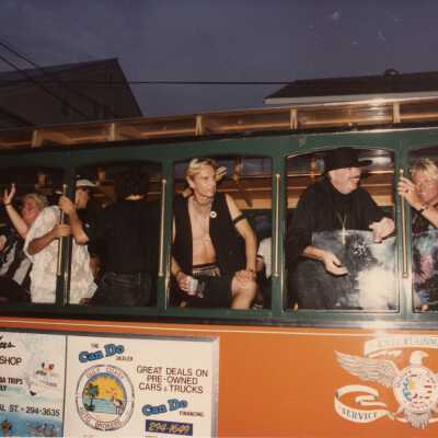 Unknown people standing on a Trolley.