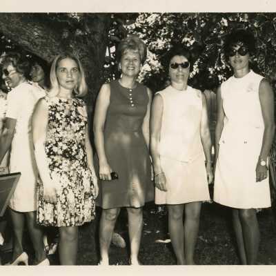 A group of woman standing outside