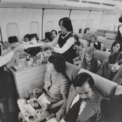 Pan Am flight attendants serving passengers