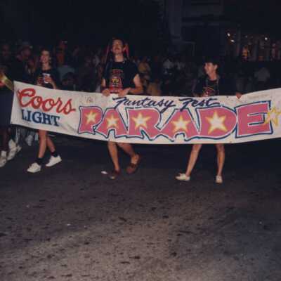 The Fantasy Fest banner being walked down the street.