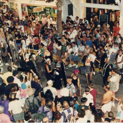 People walking in the parade dressed at the Hollywood letters.