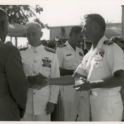 Men in uniform shaking hands and talking