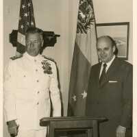 2 Men standing next to a podium