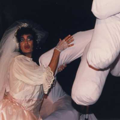 Unknown person dressed up with a float in the parade.