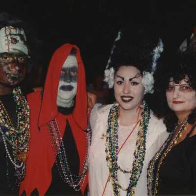 Four unknown people dressed up.
