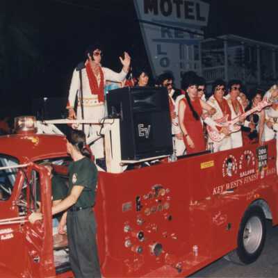 Unknown people dressed up on the Rick's complex float.