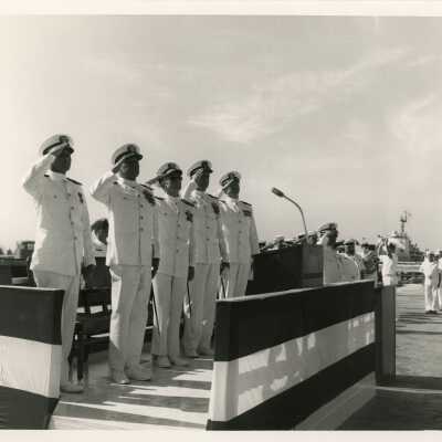 Men in uniform at a ceremony.