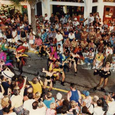 Unknown people dressed up and dancing on the street for the parade.