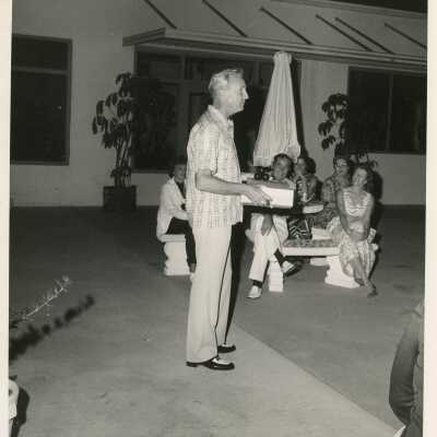 Unknown man talking to a group of people