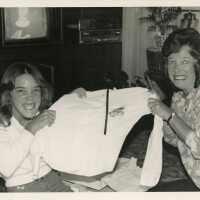 2 Woman pulling on a shirt