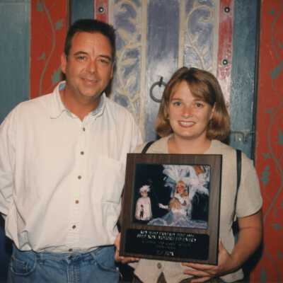 Unknown woman and man with a plaque.