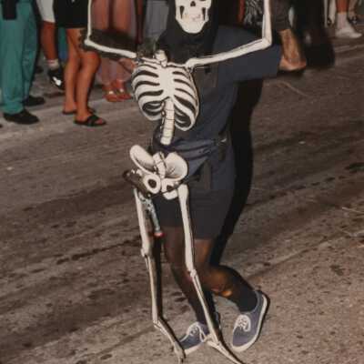 Unknown person dressed up walking in the street for the parade.