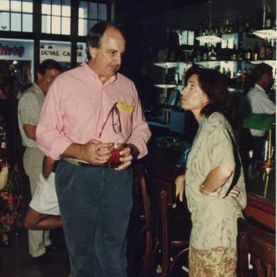 Rita Troxel talking to an unknown man at the Fantasy Fest sponsor party.