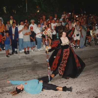 Unknown people dressed up in the street walking in the parade.