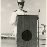 An unknown man in uniform standing at a podium