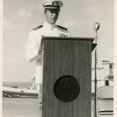 An unknown man in uniform standing at a podium