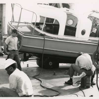 U.S. Navy men working on a boat