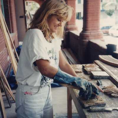 An unknown woman working on the terra cotta outside on the porch.