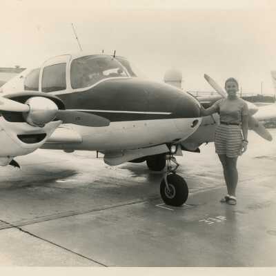 Unknown woman next to a plane