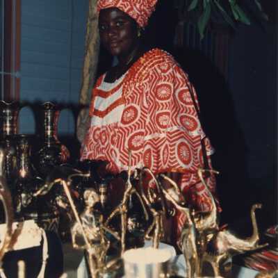 Unknown lady selling items at a Goombay booth.