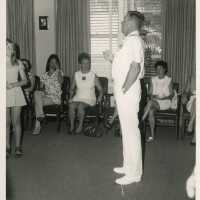 An unknown man talking to a group of people