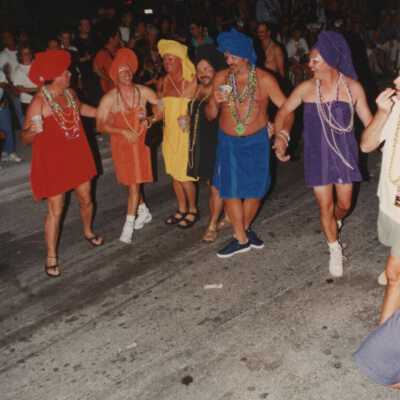 Unknown people dressed up in towels walking down the street for the parade.