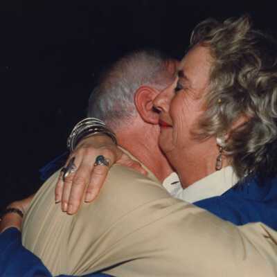 Unknown man and woman hugging at the awards ceremony.