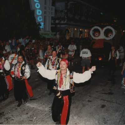 Unknown people dressed up walking in the street for the parade.