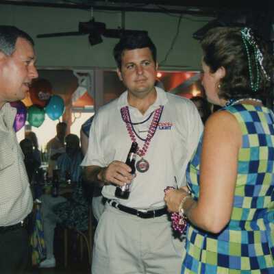 Three unknown people at a ceremony.