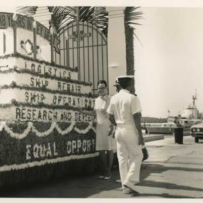 Unknown people standing next to a float