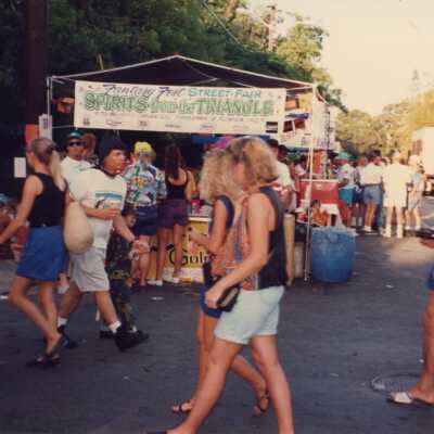 Unknown people walking in the street at the fair.