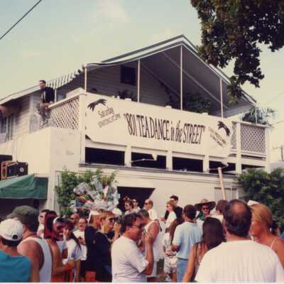 Unknown people walking around at the street fair in front of 801 Duval Street.