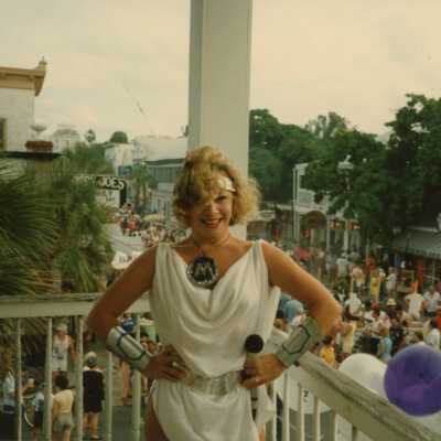 Unknown woman dressed in a toga on a balcony.