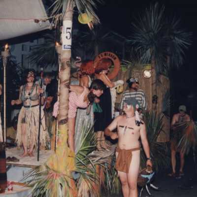 Unknown people dressed up on a float in the parade.