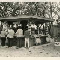 A group of people standing at a snack shack
