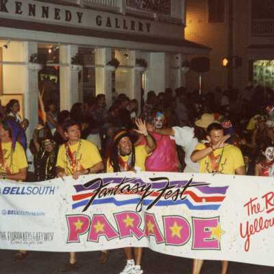 Unknown people holding the fantasy fest banner.