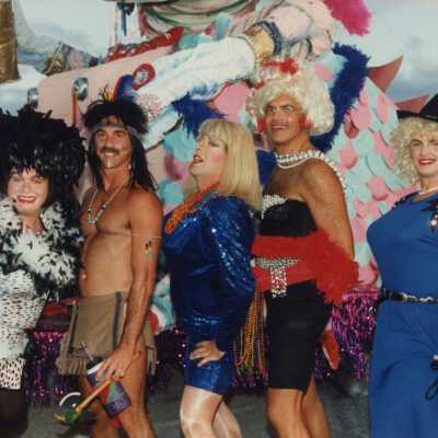 Unknown people standing near a float.