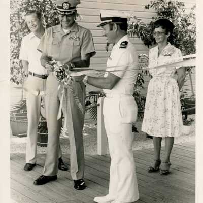 Unknown men in uniform cutting a ribbon to a grand opening