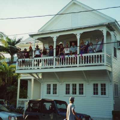 A group of unknown people on the balcony of a building.