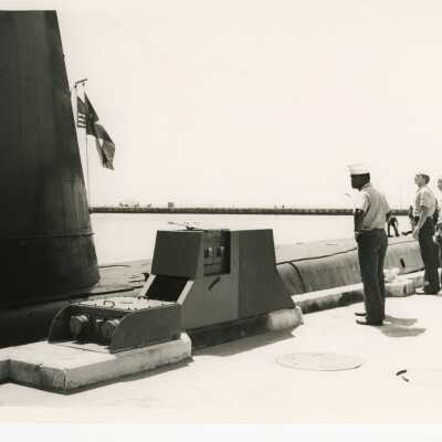 U.S. Navy submarine and men standing near by