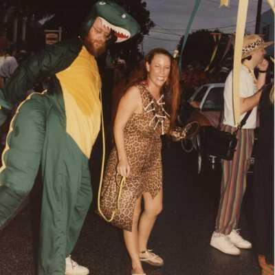 Unknown people dressed up standing outside.