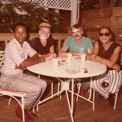 Four unknown people sitting at a table.