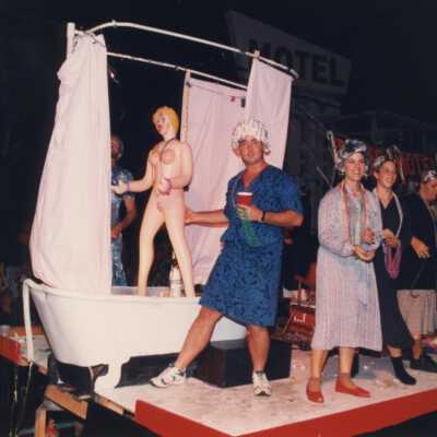 Unknown people dressed up on a float that reads Bates Motel.