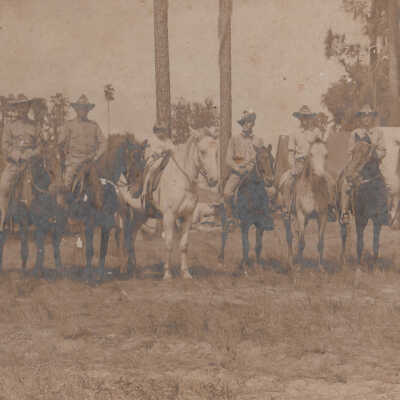 Group of soldiers and a child on horses